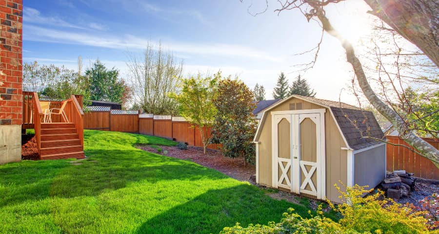 Fenced backyard with storage shed in Syracuse